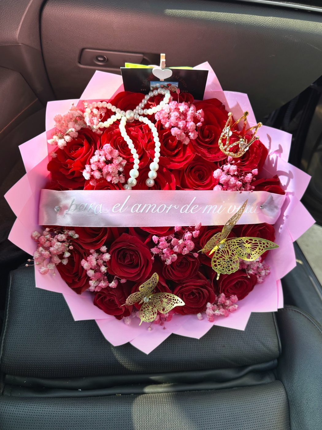 Red roses with a pearl bow and a gold crown